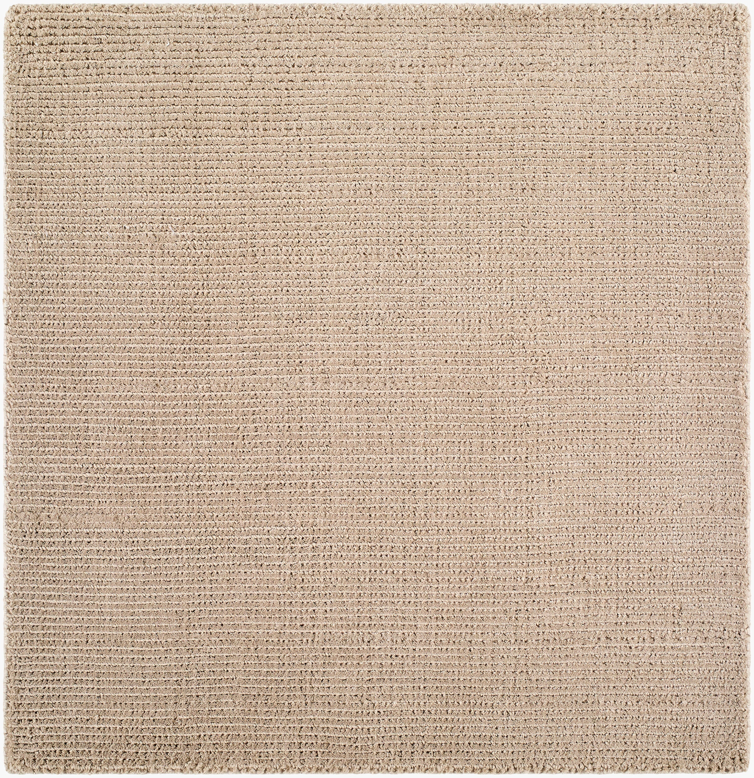Solid beige handwoven P.E.T fiber rug with fine ribbed texture, available in multiple sizes.