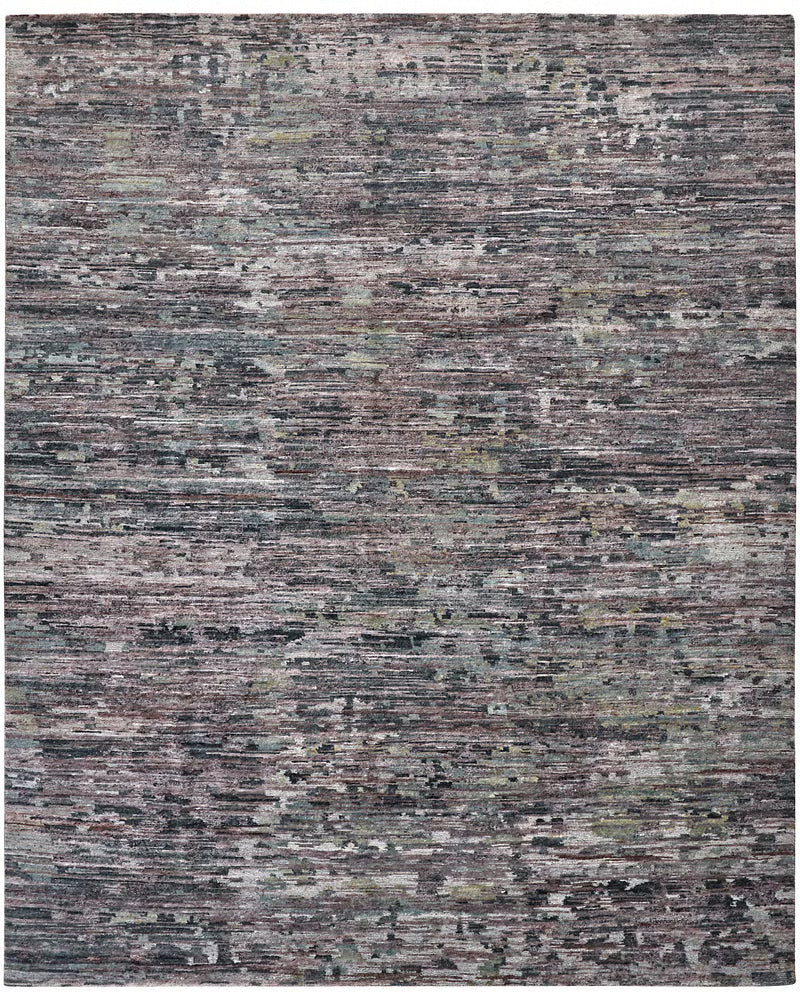 Multicolor handknotted wool rug with a striated abstract pattern in mauve, sage, and slate, shown corner-folded.