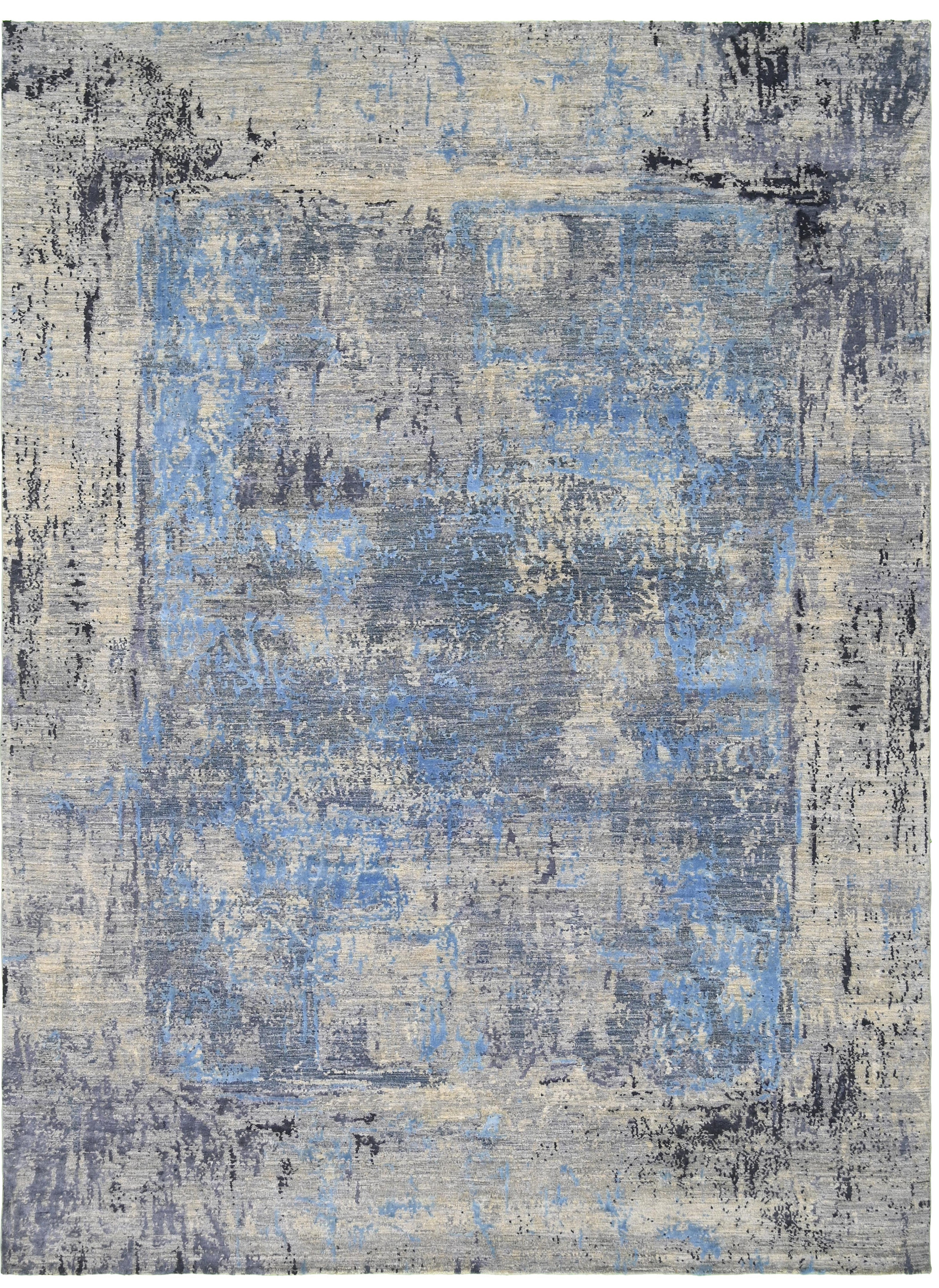 An abstract area rug with a distressed, vintage-style pattern featuring a central blue rectangle surrounded by textured gray, beige, and black borders.