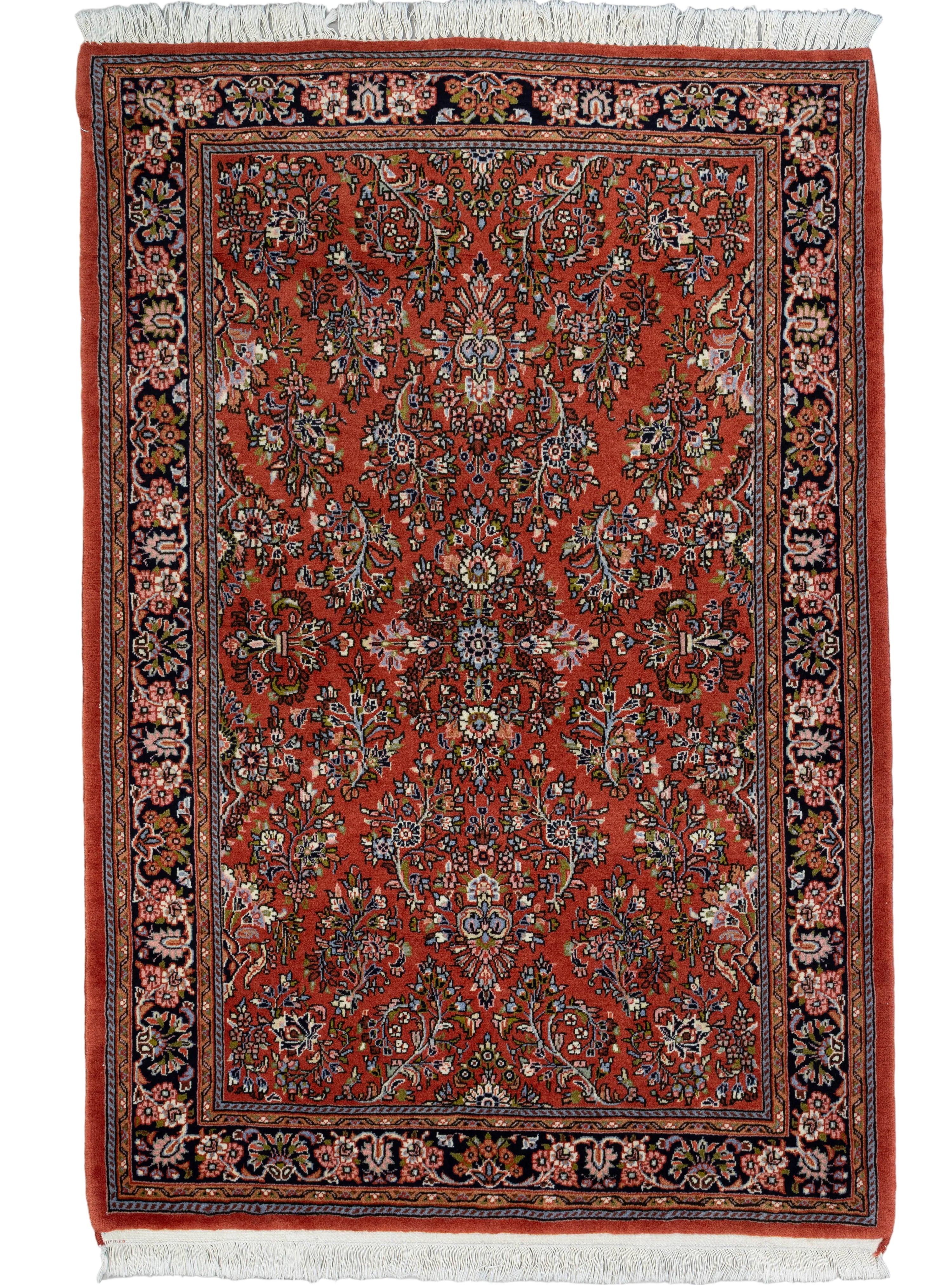 Brick red hand-knotted Persian Sarouk wool rug with all-over floral vine pattern, 3' x 5'.