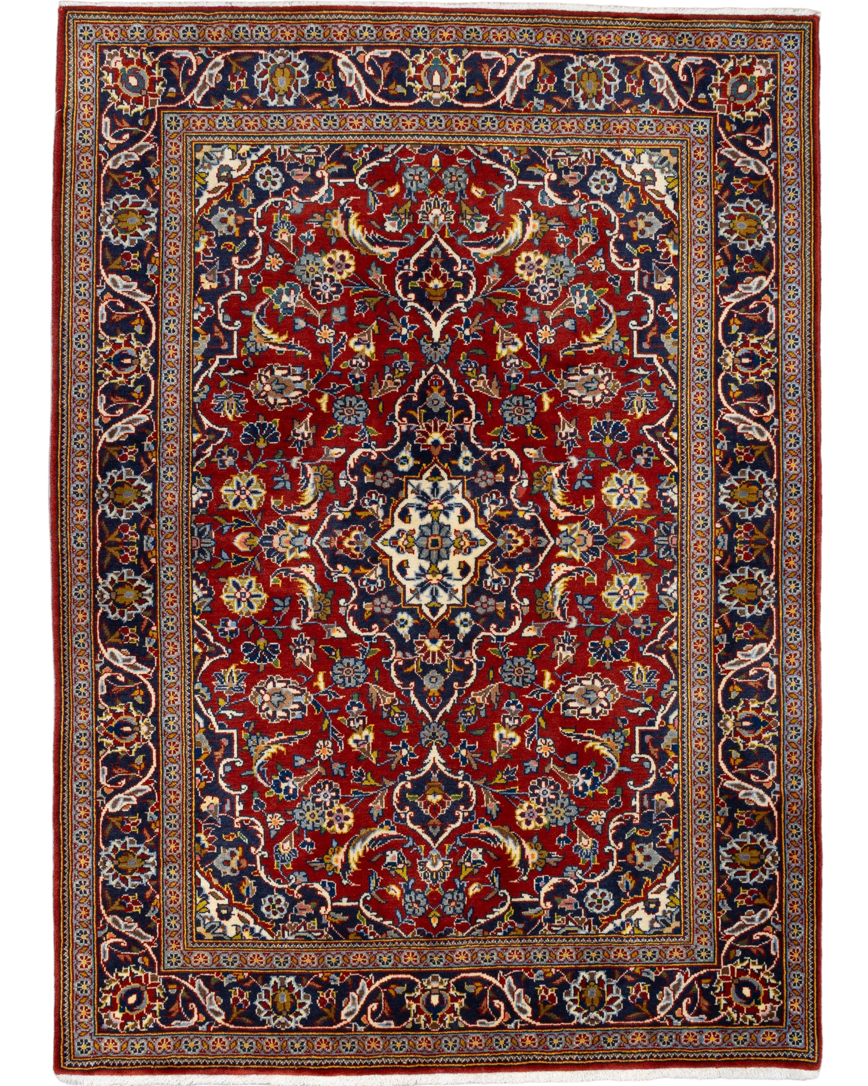 Hand-knotted Persian Kashan wool rug in crimson red with a navy and ivory star medallion, all-over floral field, and dense arabesque border, 3'7" x 4'11", made in Iran.