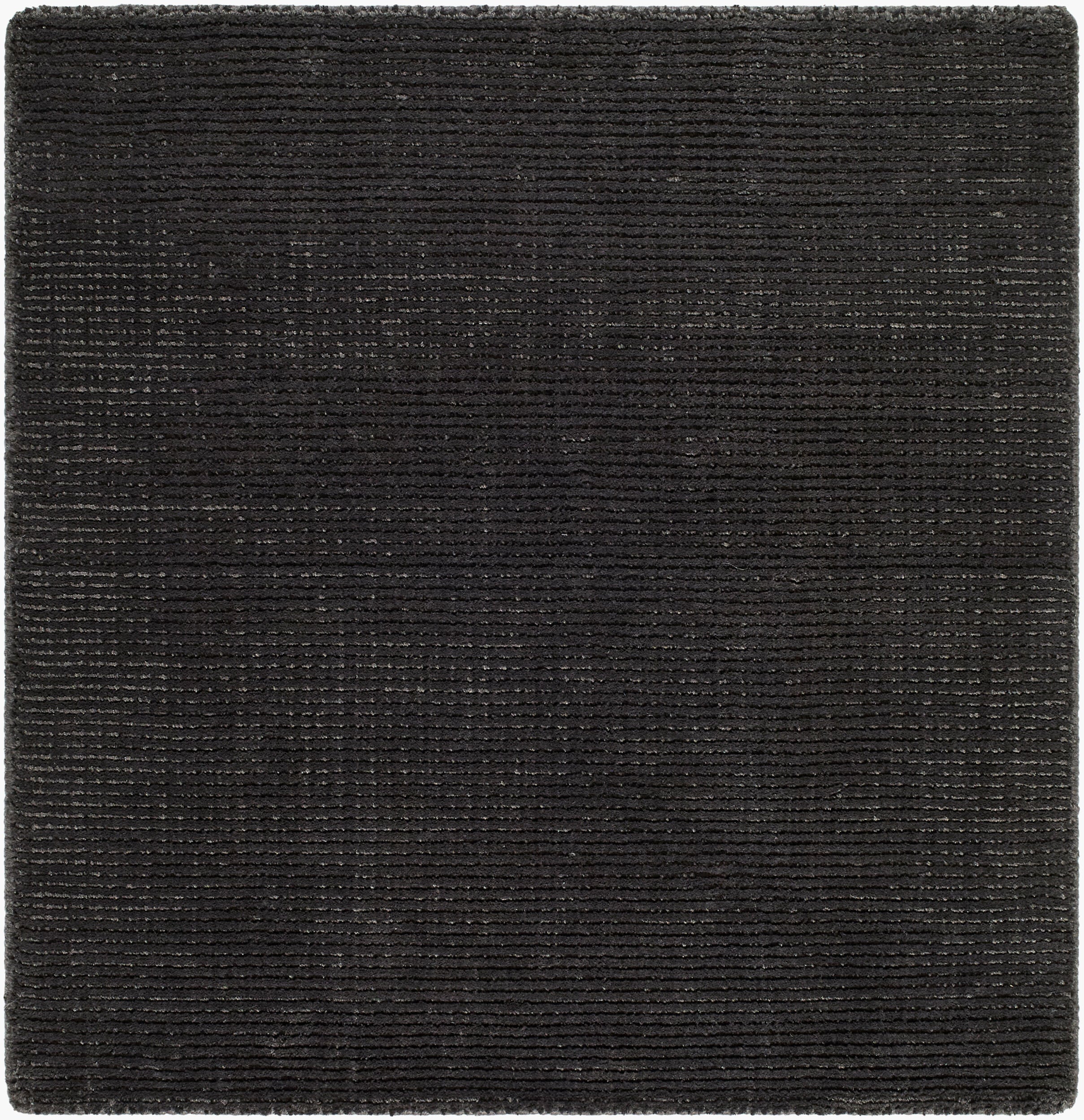 Solid black handwoven P.E.T fiber rug with fine ribbed texture, available in multiple sizes.