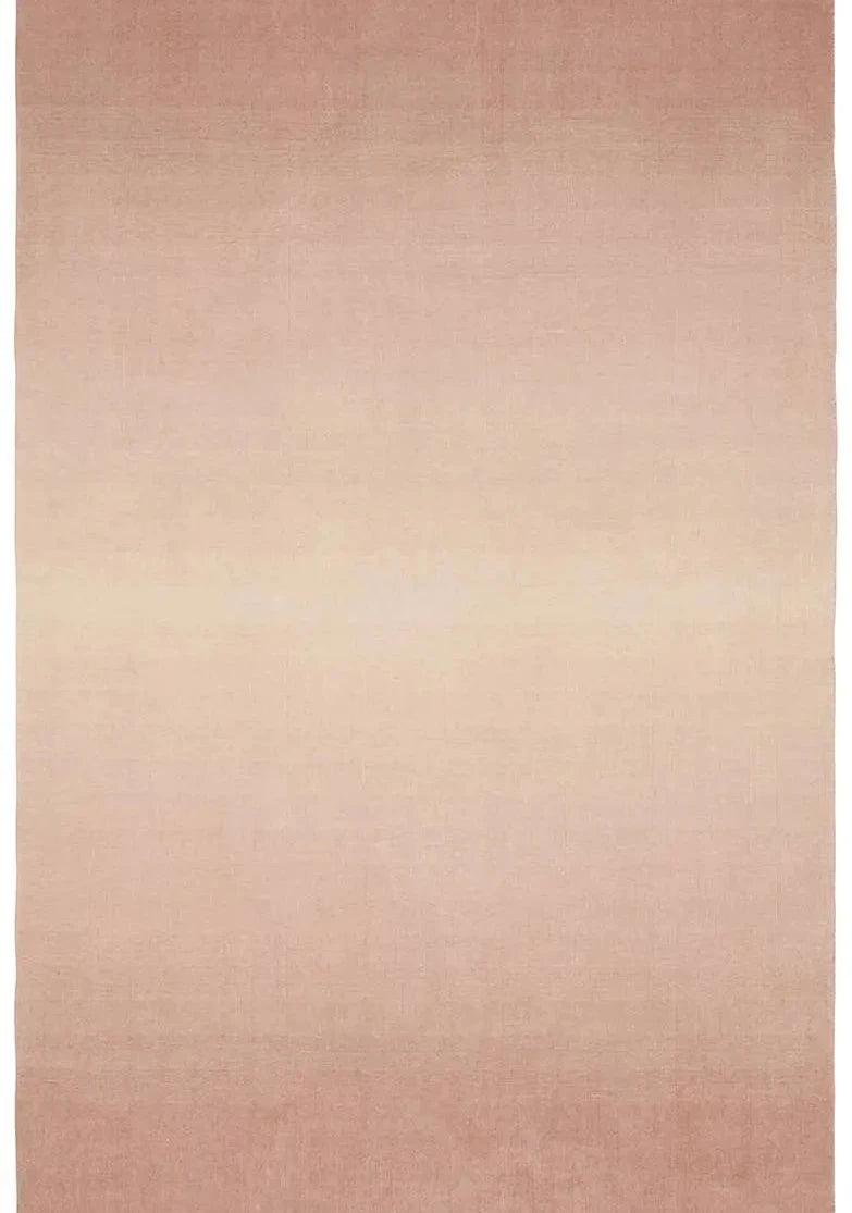 Blush handwoven wool rug with a soft ombré gradient fading to ivory.